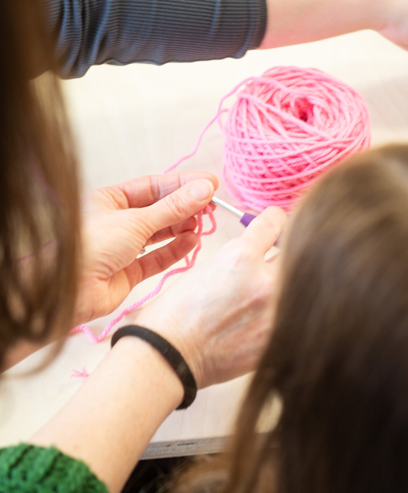 “Beginner-friendly 1.5-hour crochet class at Maker Studio Eastbourne , small welcoming workshop with tutor Kate teaching basic crochet stitches, providing yarn, hooks, and guidance, with participants taking home their completed projects and instructions.