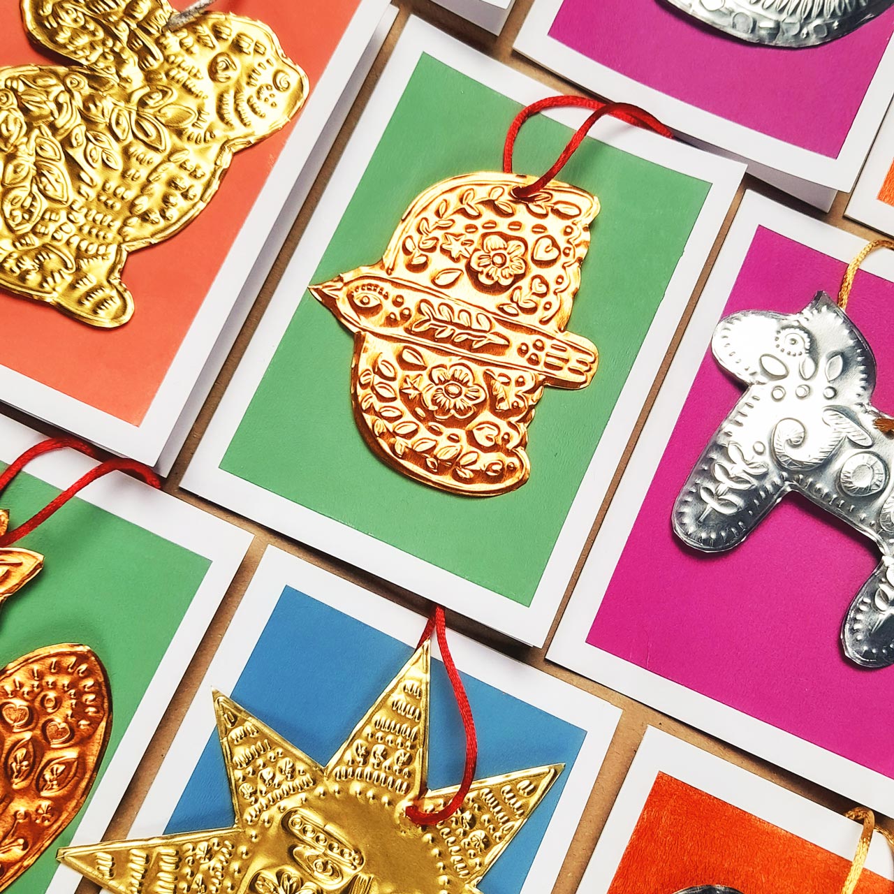 Festive tin embossing workshop at Maker Studio Eastbourne ,  illustrator Nina Mooncie teaching beginners to create handmade folk art Christmas decorations using metallic foil and embossing tools.
