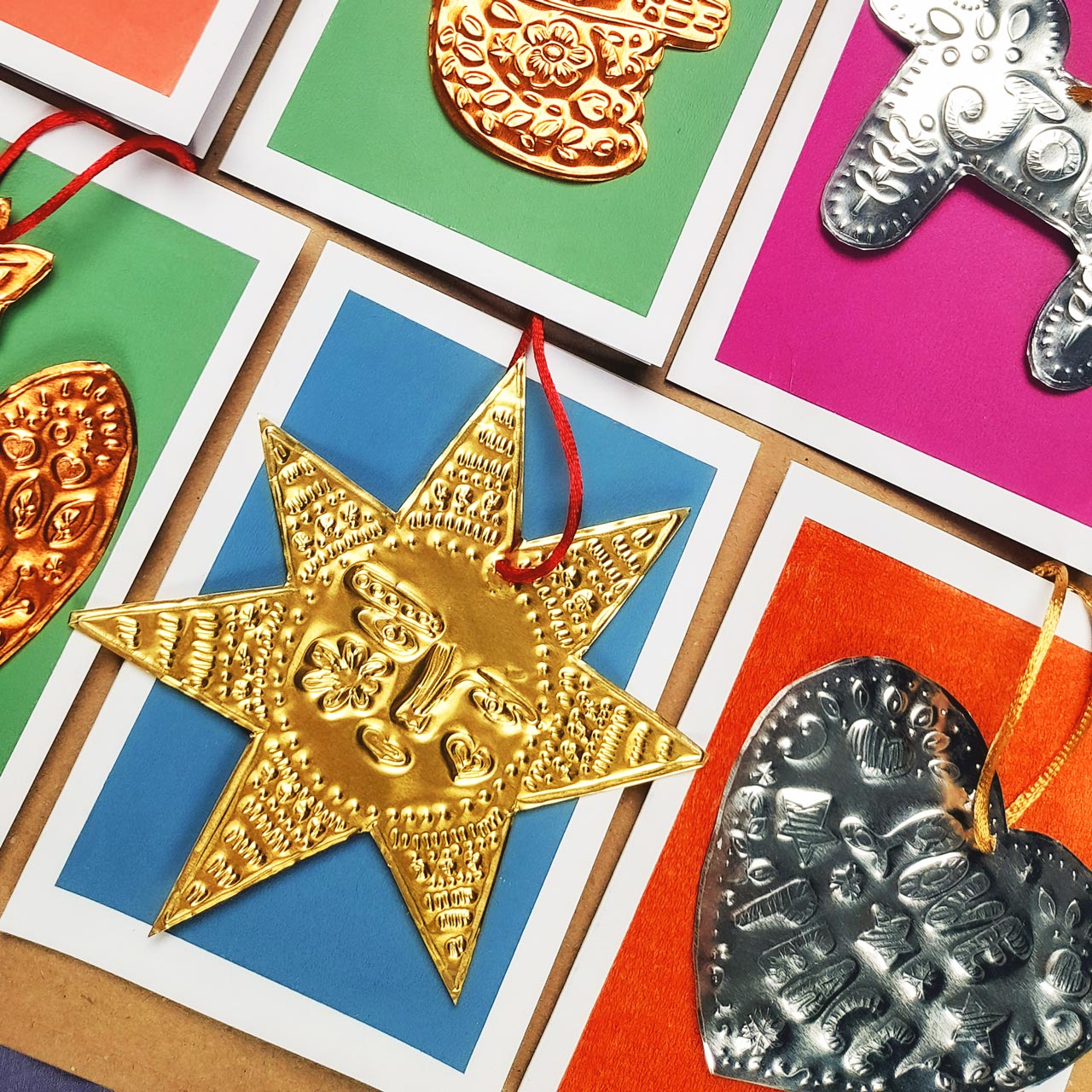 Festive tin embossing workshop at Maker Studio Eastbourne ,  illustrator Nina Mooncie teaching beginners to create handmade folk art Christmas decorations using metallic foil and embossing tools.