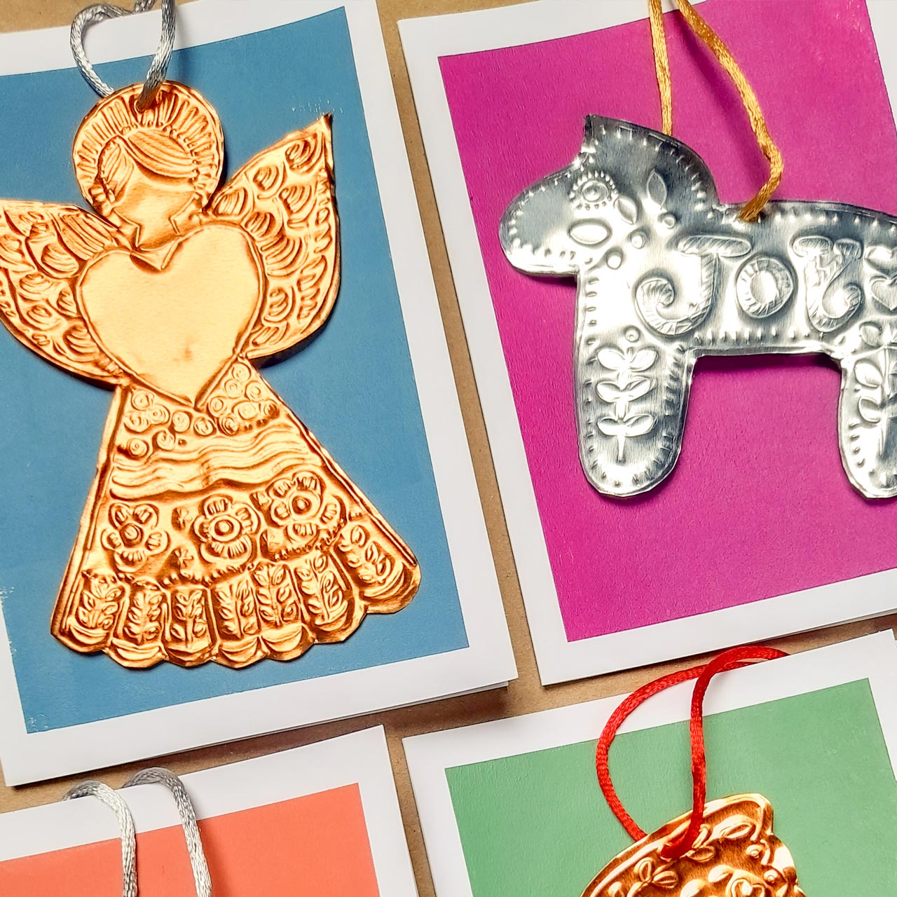 Festive tin embossing workshop at Maker Studio Eastbourne ,  illustrator Nina Mooncie teaching beginners to create handmade folk art Christmas decorations using metallic foil and embossing tools.